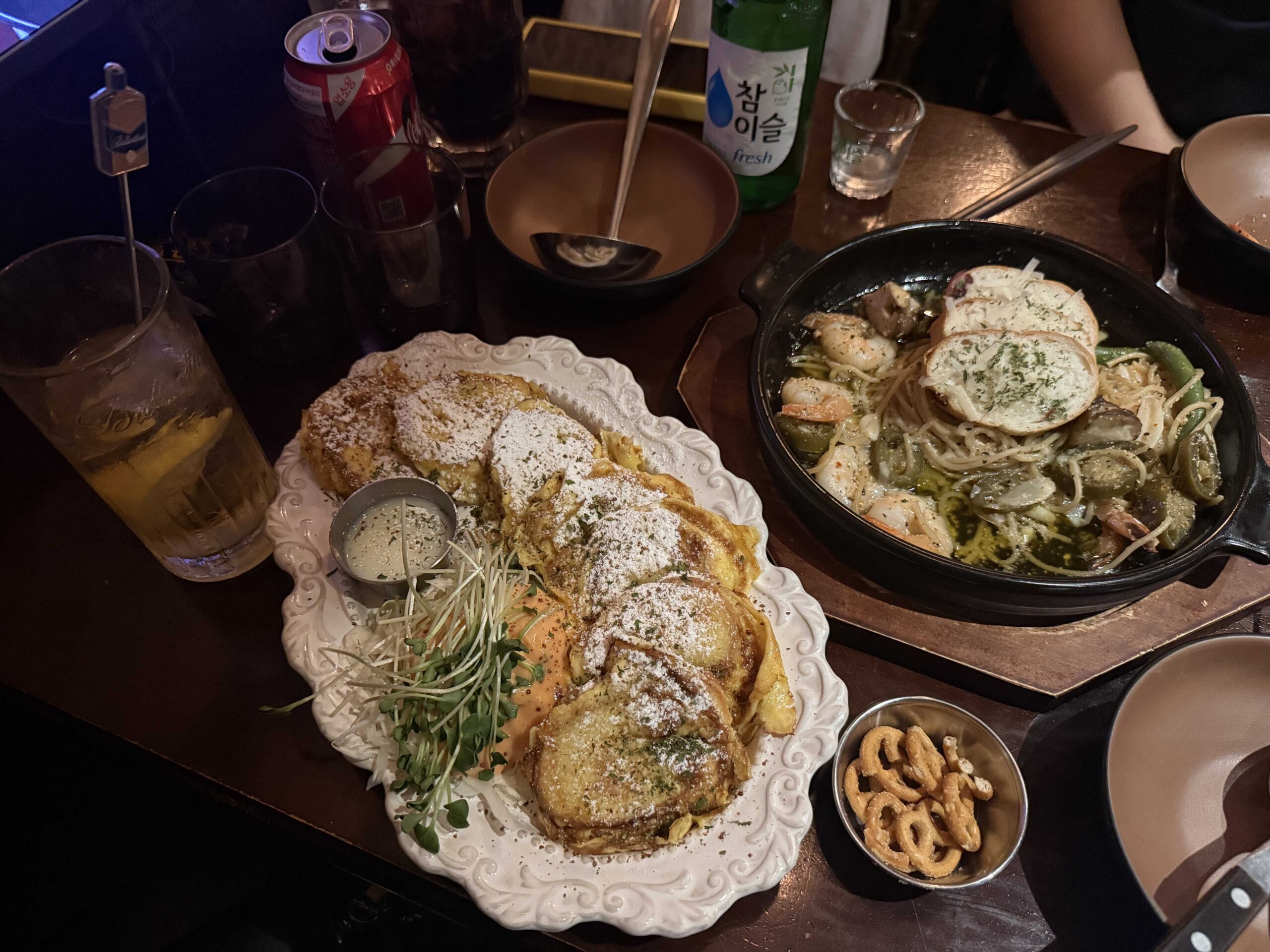 Table spread of sweet french toast and samonim gambas with soju and lemon beer at Geumbyeol Maekju Bangi