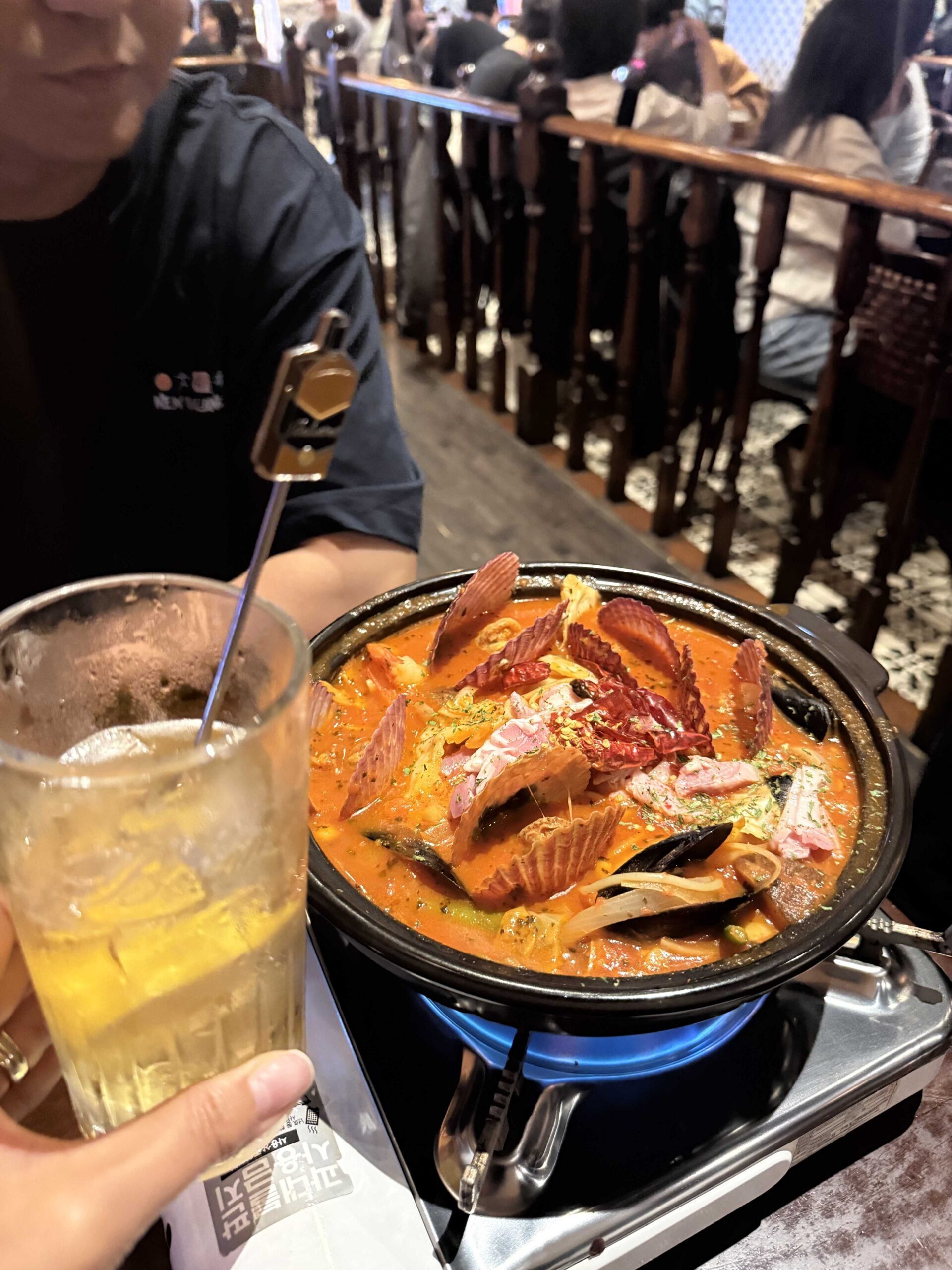 Tomato haejang pastang bubbling on a portable burner with lemon draft beer at Geumbyeol Maekju Bangi