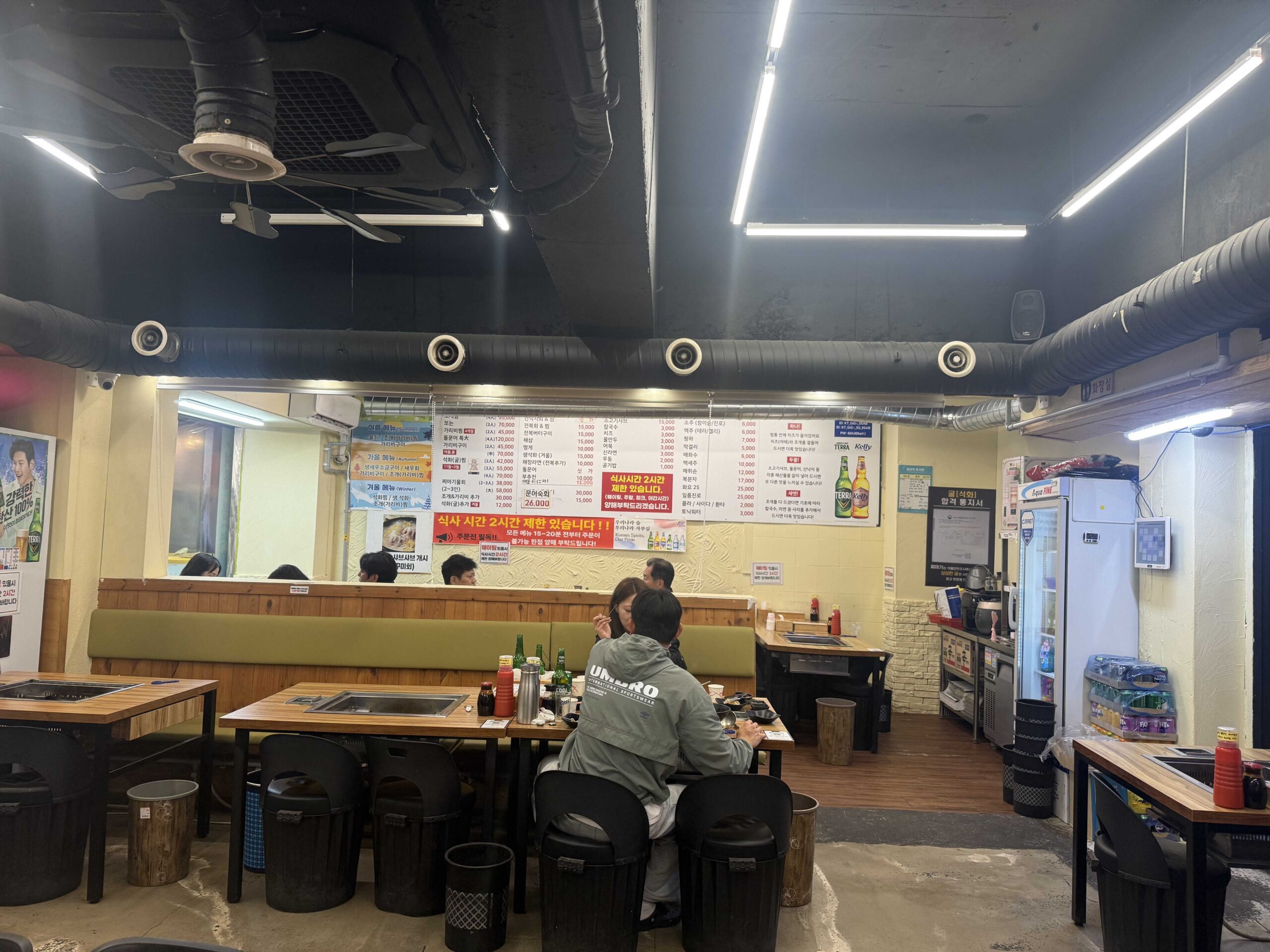 Jjimagi Jamsil Bangi menu board showing seafood steamer prices and add-on options