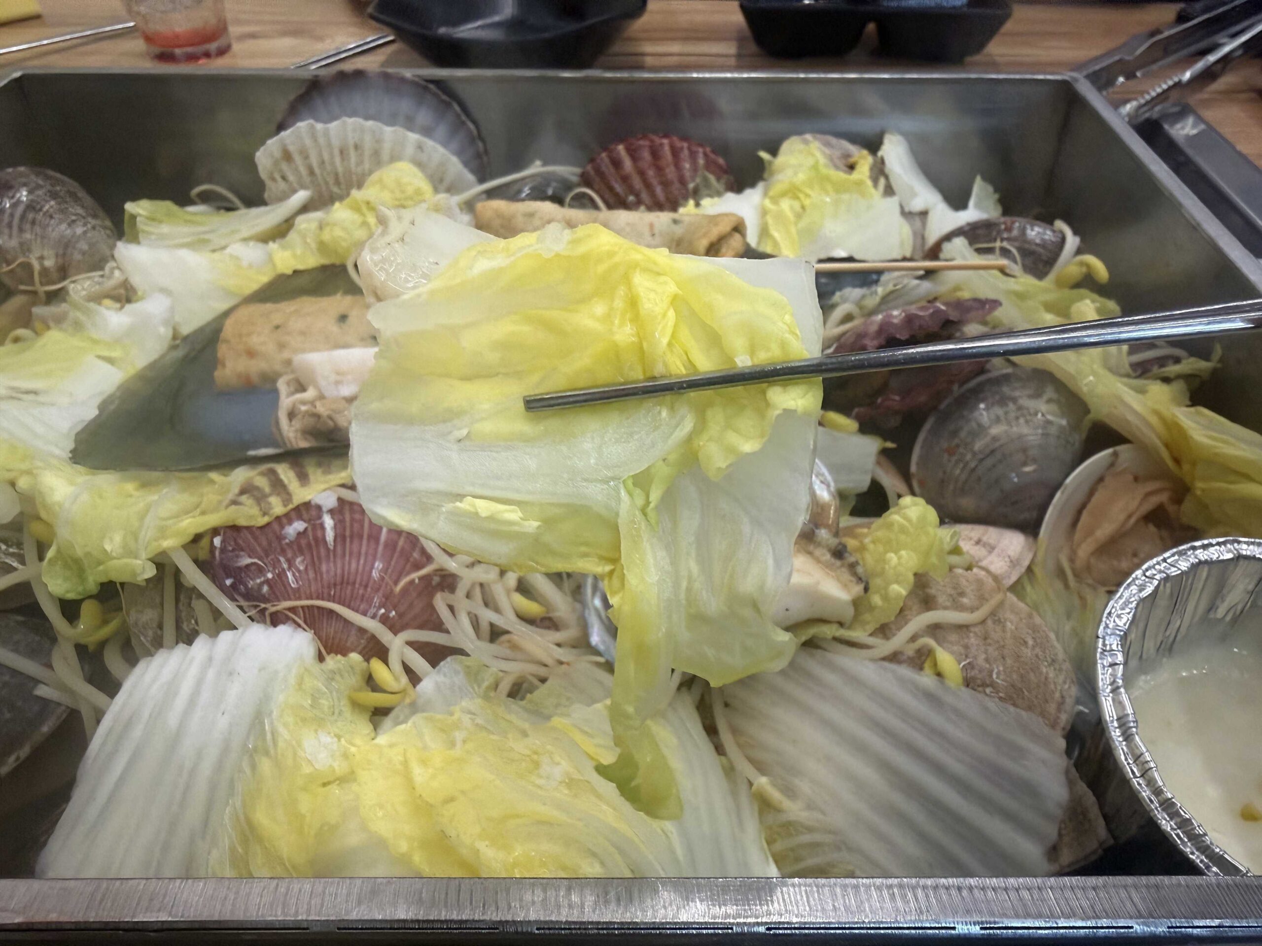 Steamed cabbage leaves at Jjimagi Jamsil Bangi soaking up seafood broth