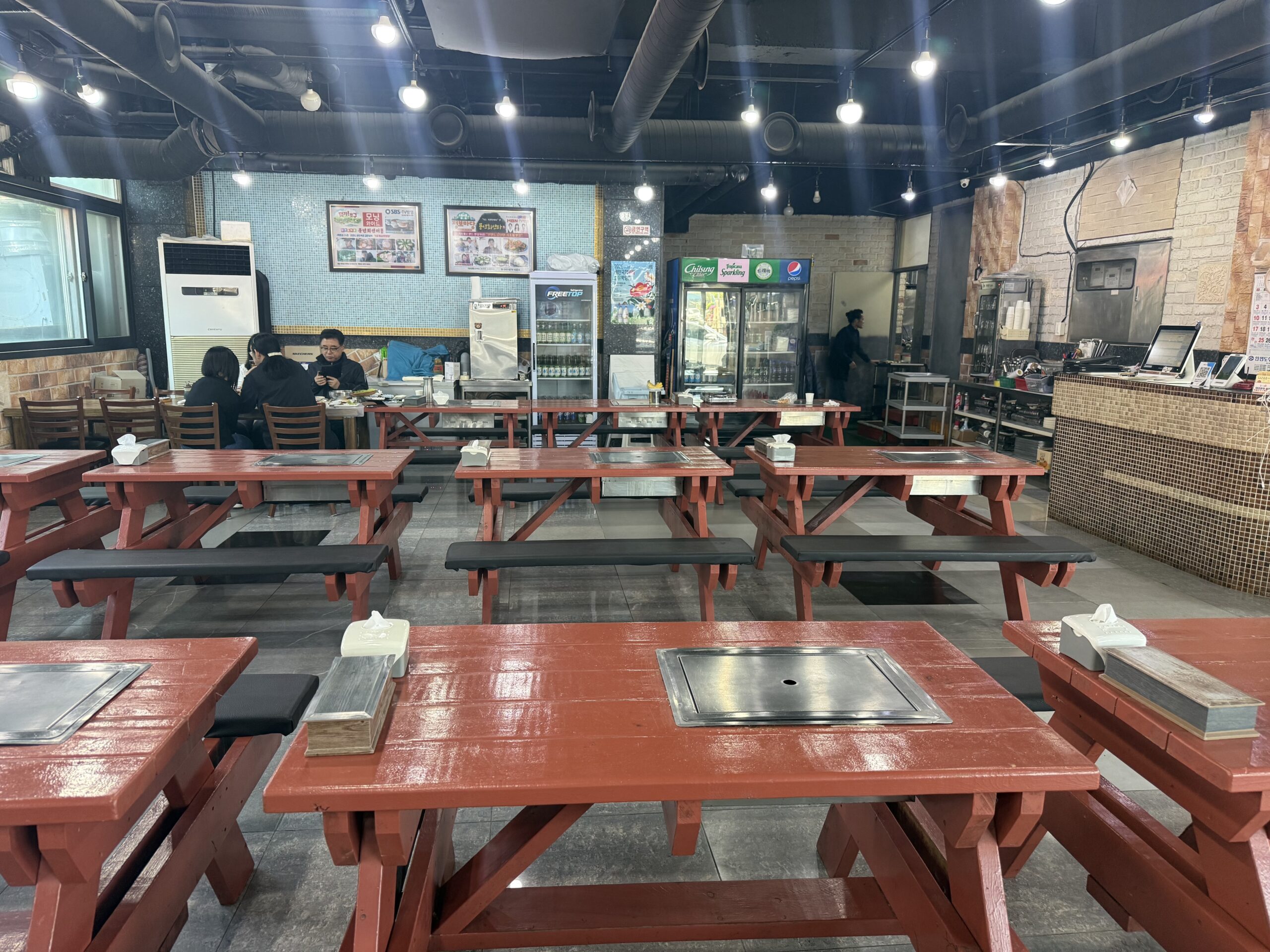 Picnic-style tables and built-in grills inside Pungnyeon Hwesenta