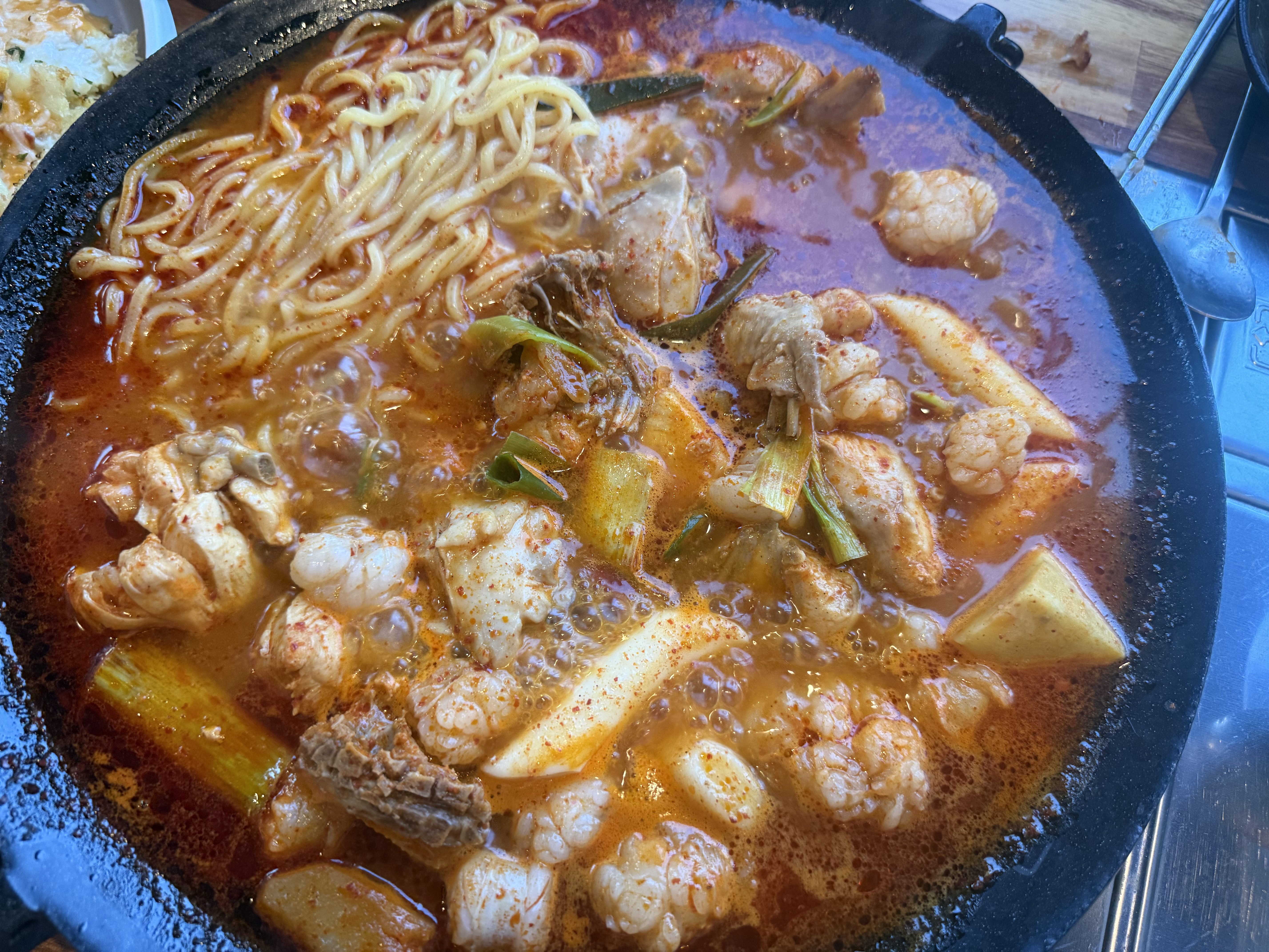 Ramen noodles added to gopdori-tang stew at Pocha Cheonguk Hanam