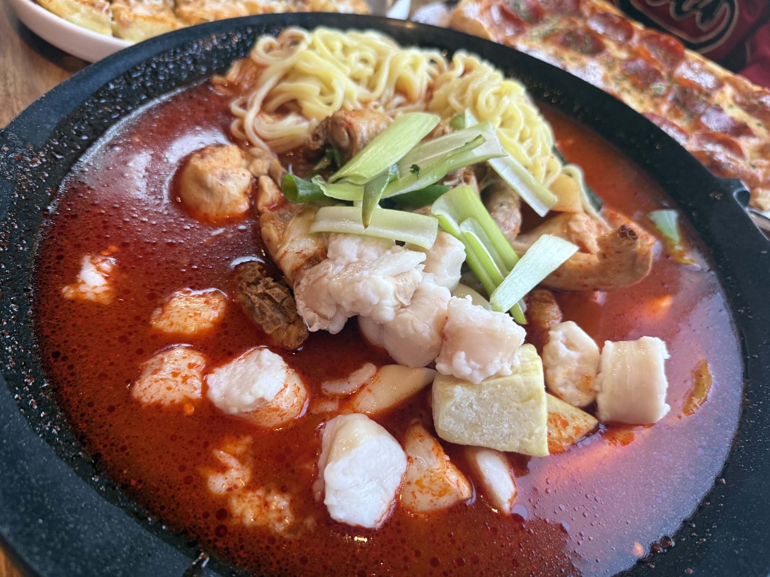 Gopdori-tang close-up with chicken intestine and green onion at Pocha Cheonguk Hanam