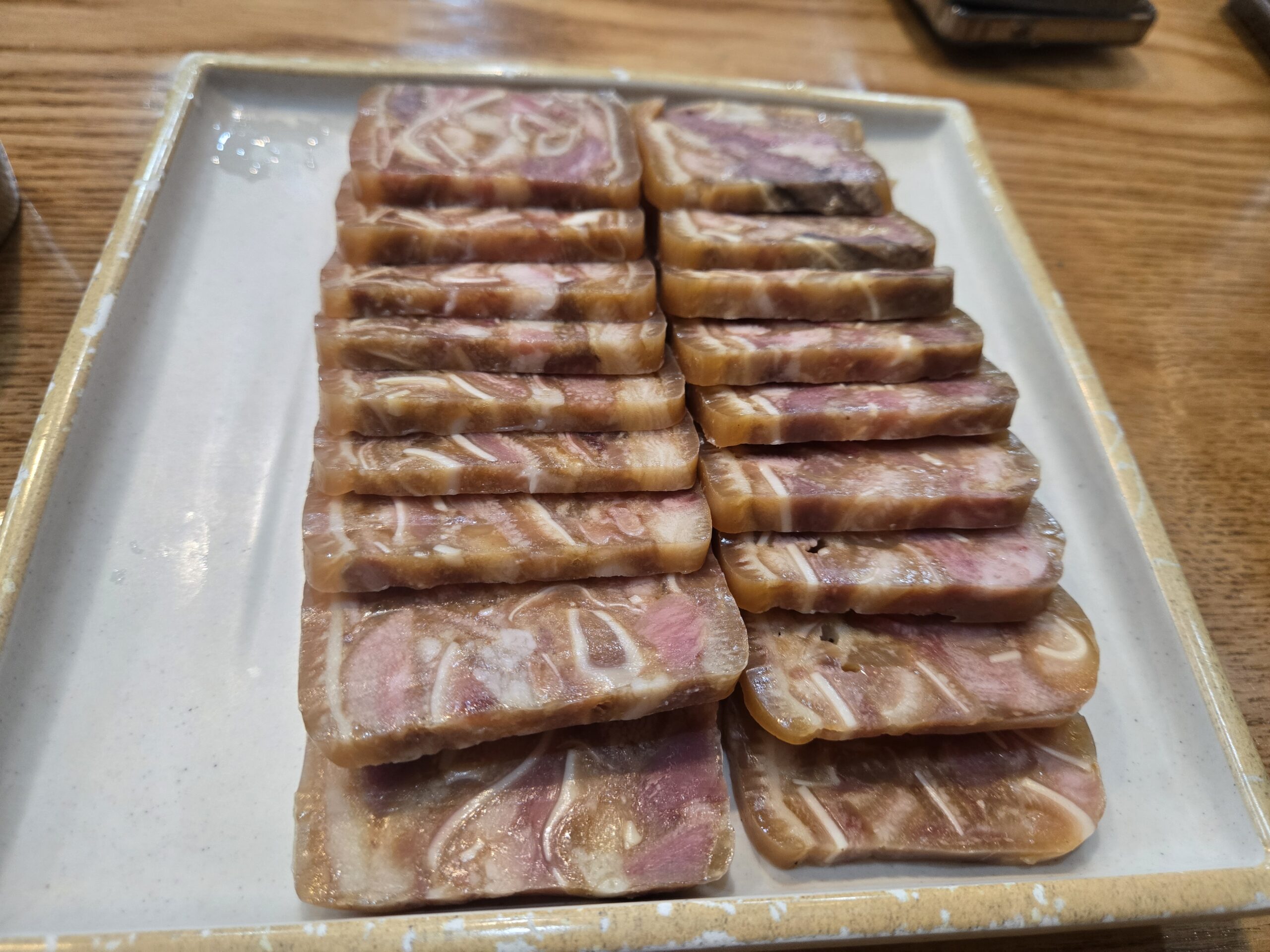 Bossam pyeonyuk pork belly slices arranged at Dammion Seongsu