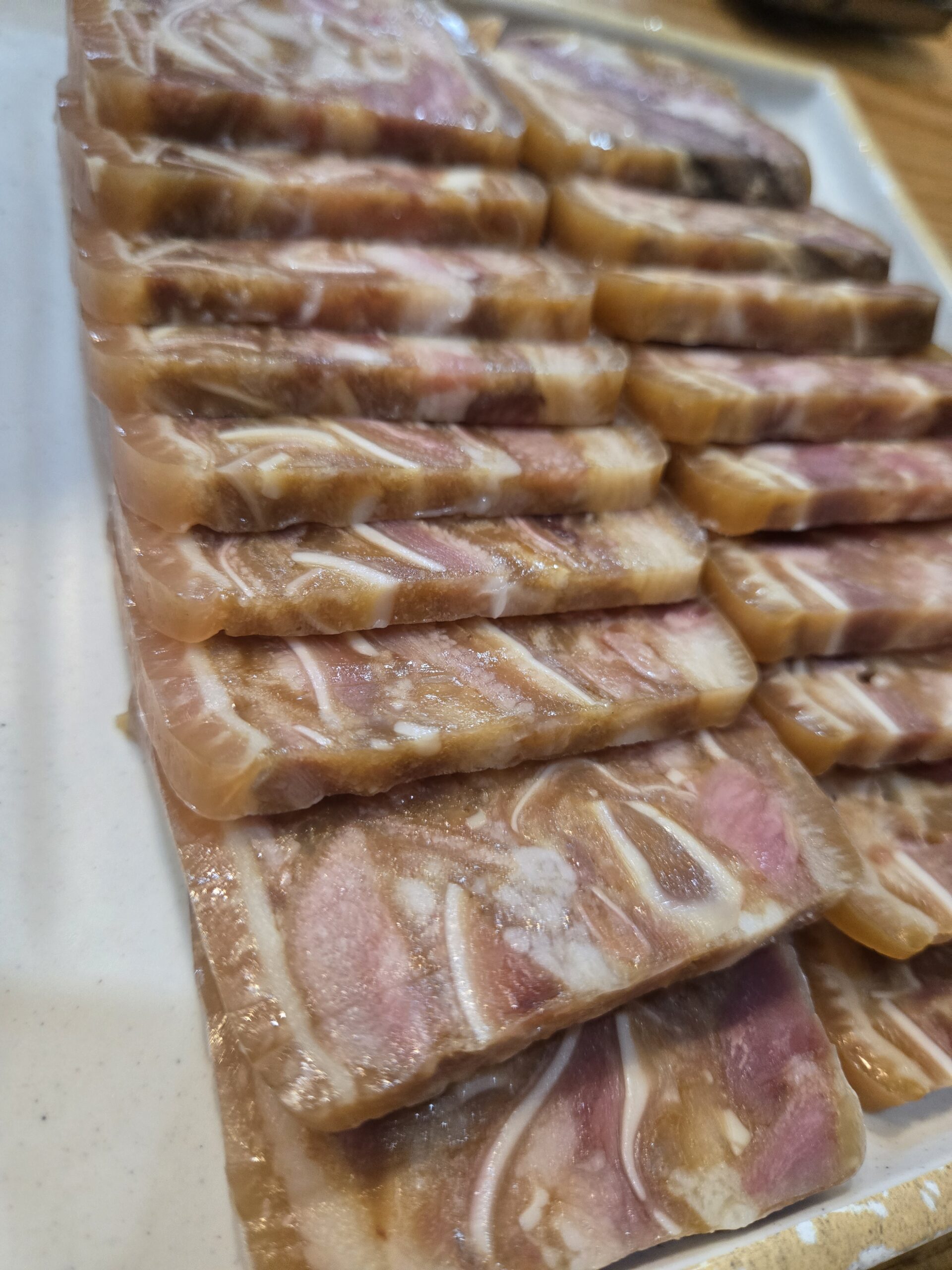 Bossam slices close-up showing fat marbling at Dammion Seongsu