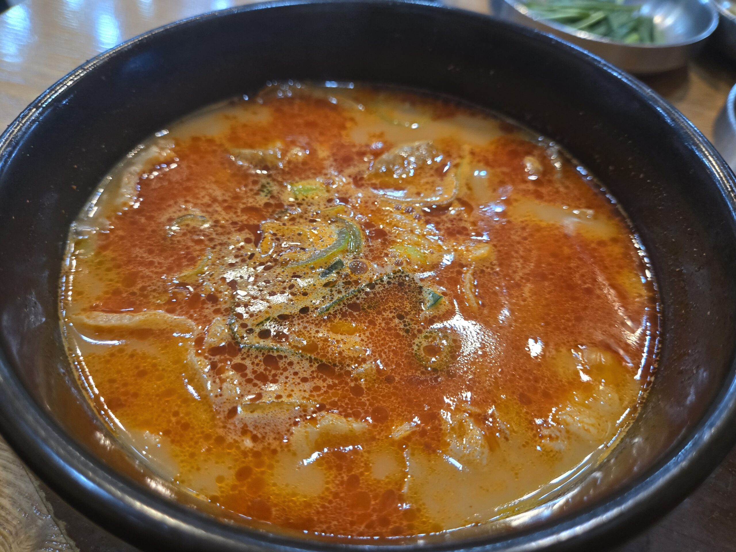 Budae gukbap broth detail with noodles and pork at Dammion Seongsu