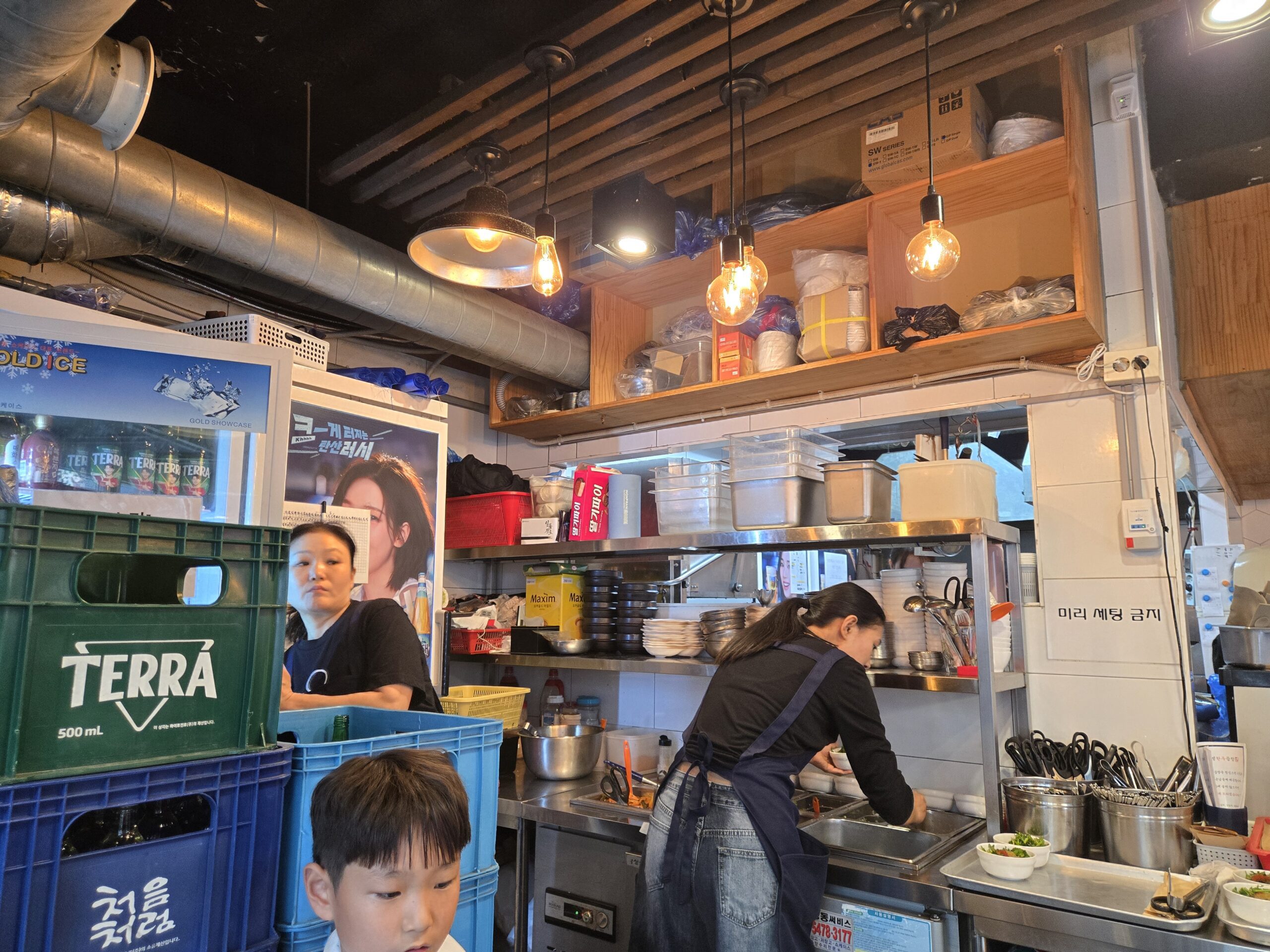Open kitchen and beverage crates inside Jinseong Hanu Gopchang Bangi