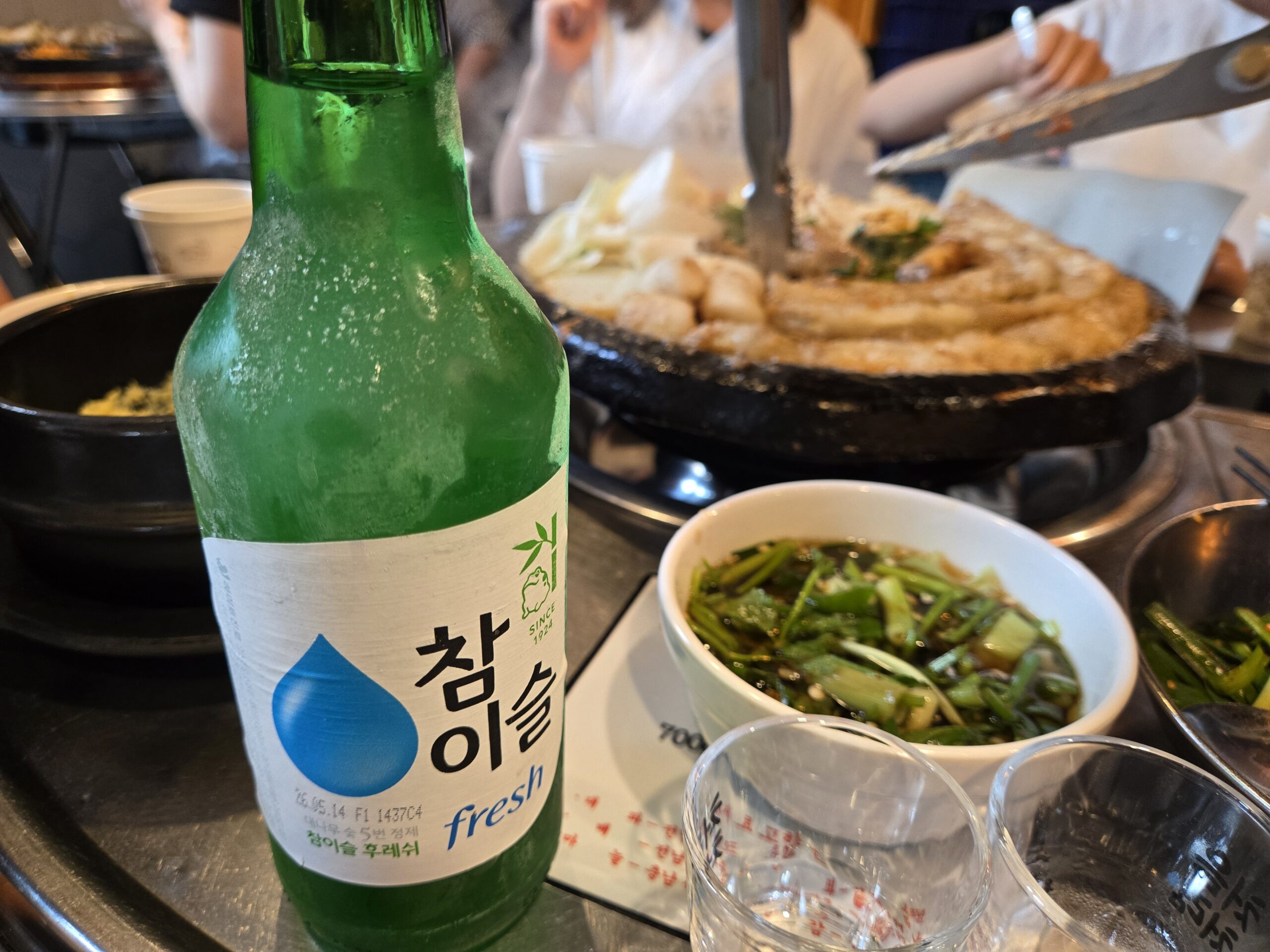 Chamisul soju bottle with gopchang plate and buchu salad at Jinseong Hanu Gopchang