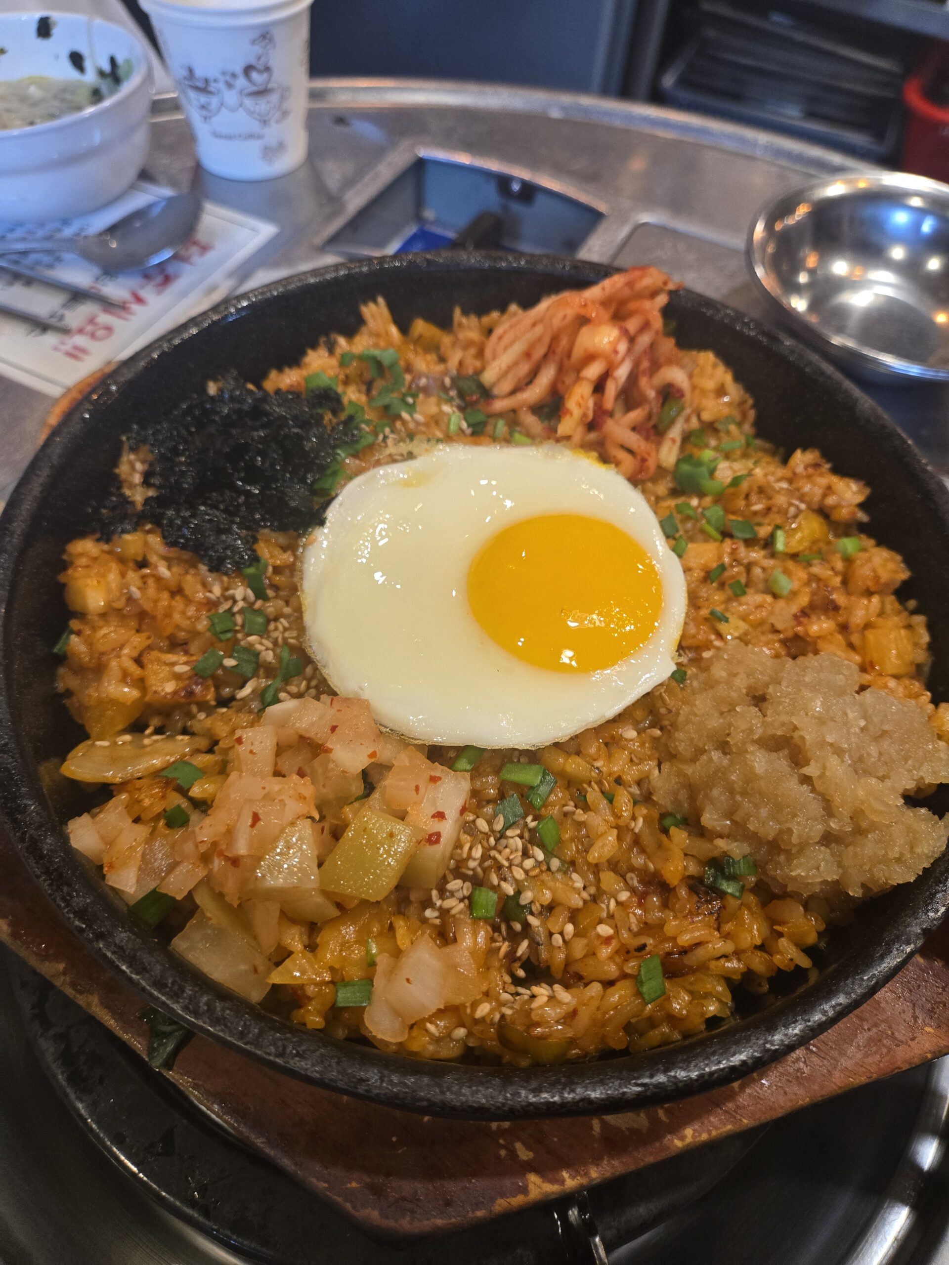 Bokkeumbap fried rice with egg on top kimchi and sesame at Jinseong Hanu Gopchang