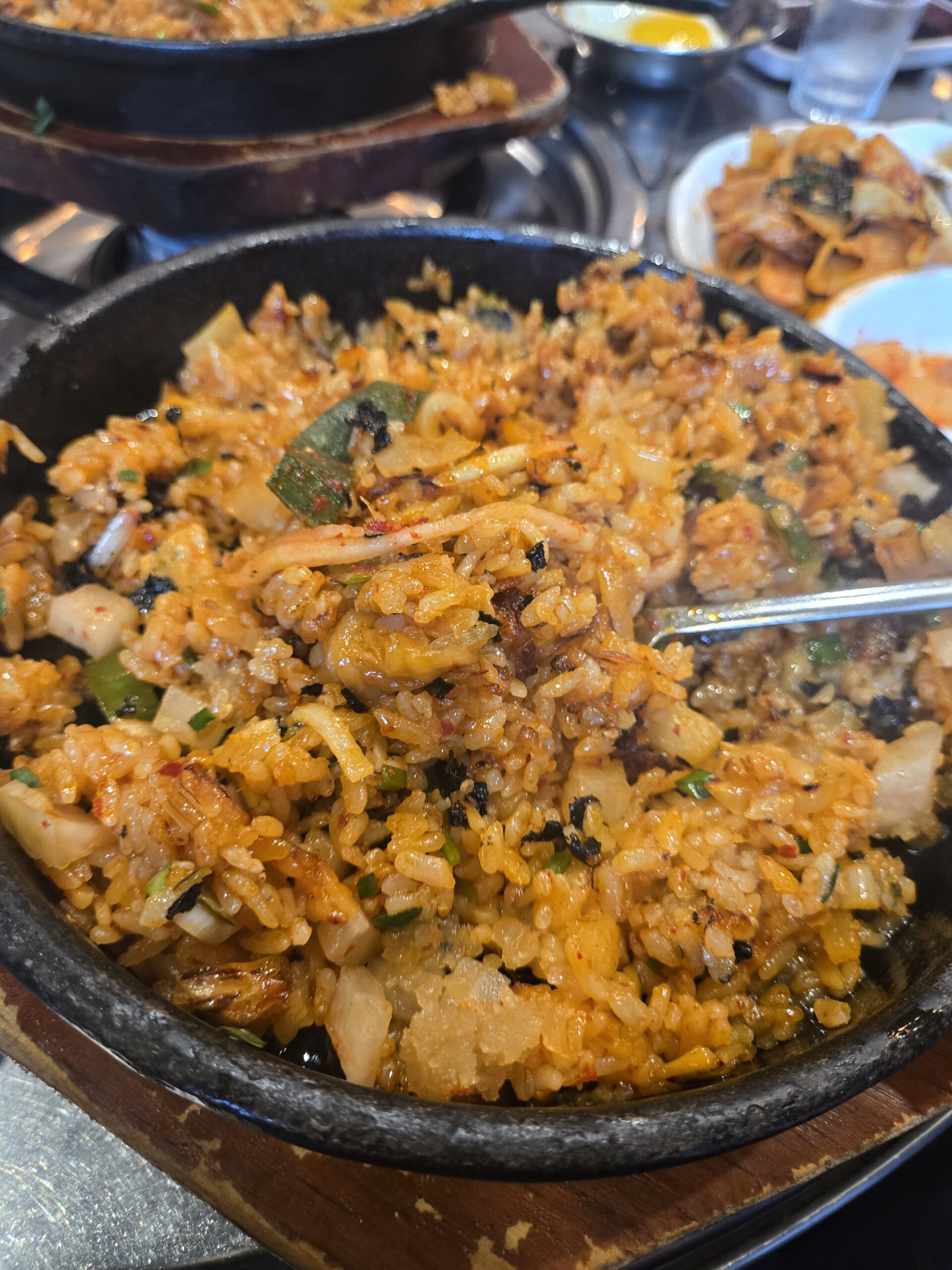 Stir-fried bokkeumbap finished and pressed on the stone plate at Jinseong Hanu Gopchang