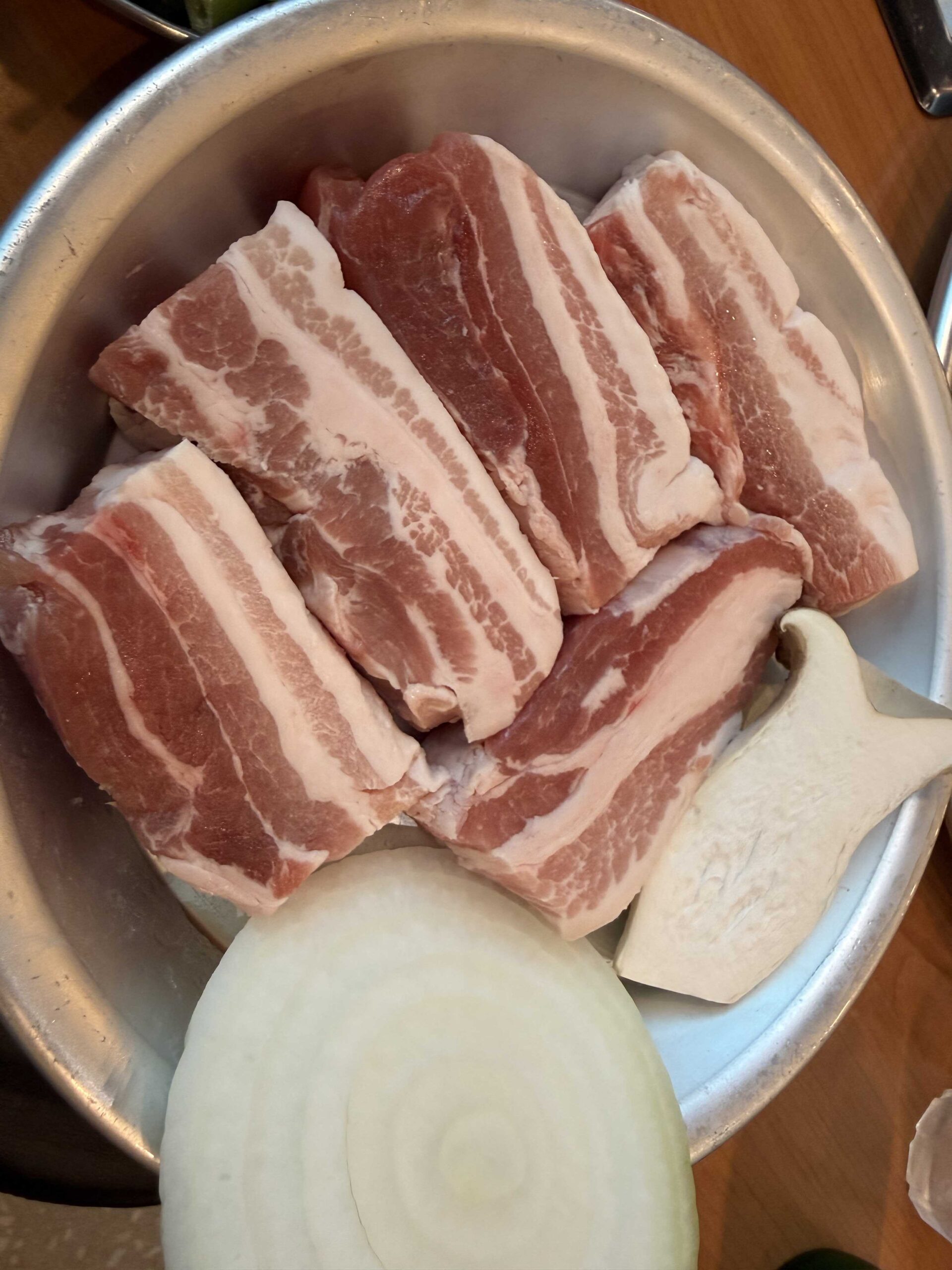 Raw Duroc black pork belly in a bowl before grilling at Sottukkeong Samgyeopsal Hanam
