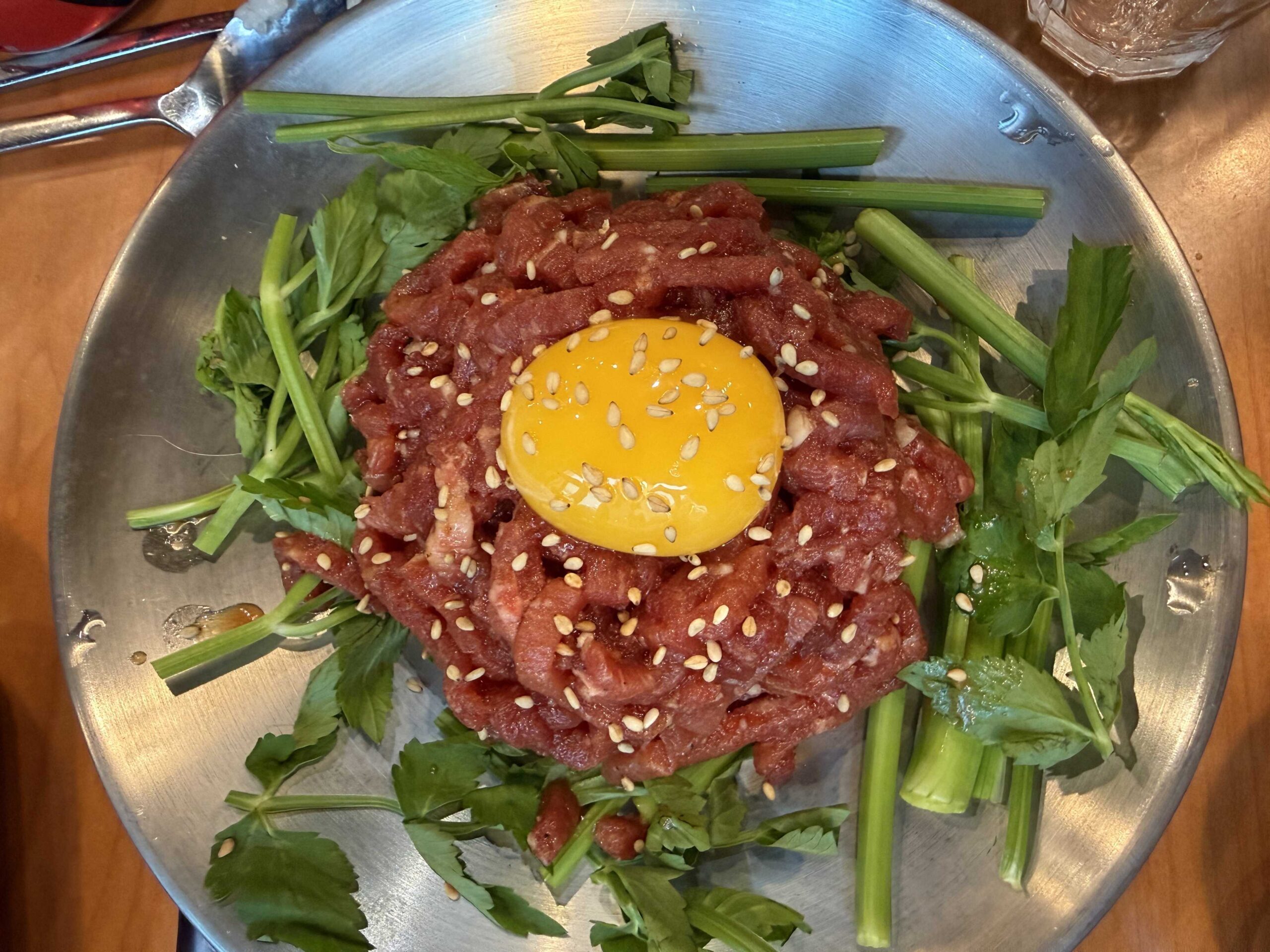 Yukhoe beef tartare with egg yolk and minari at Hyojadong Sottukkeong Samgyeopsal