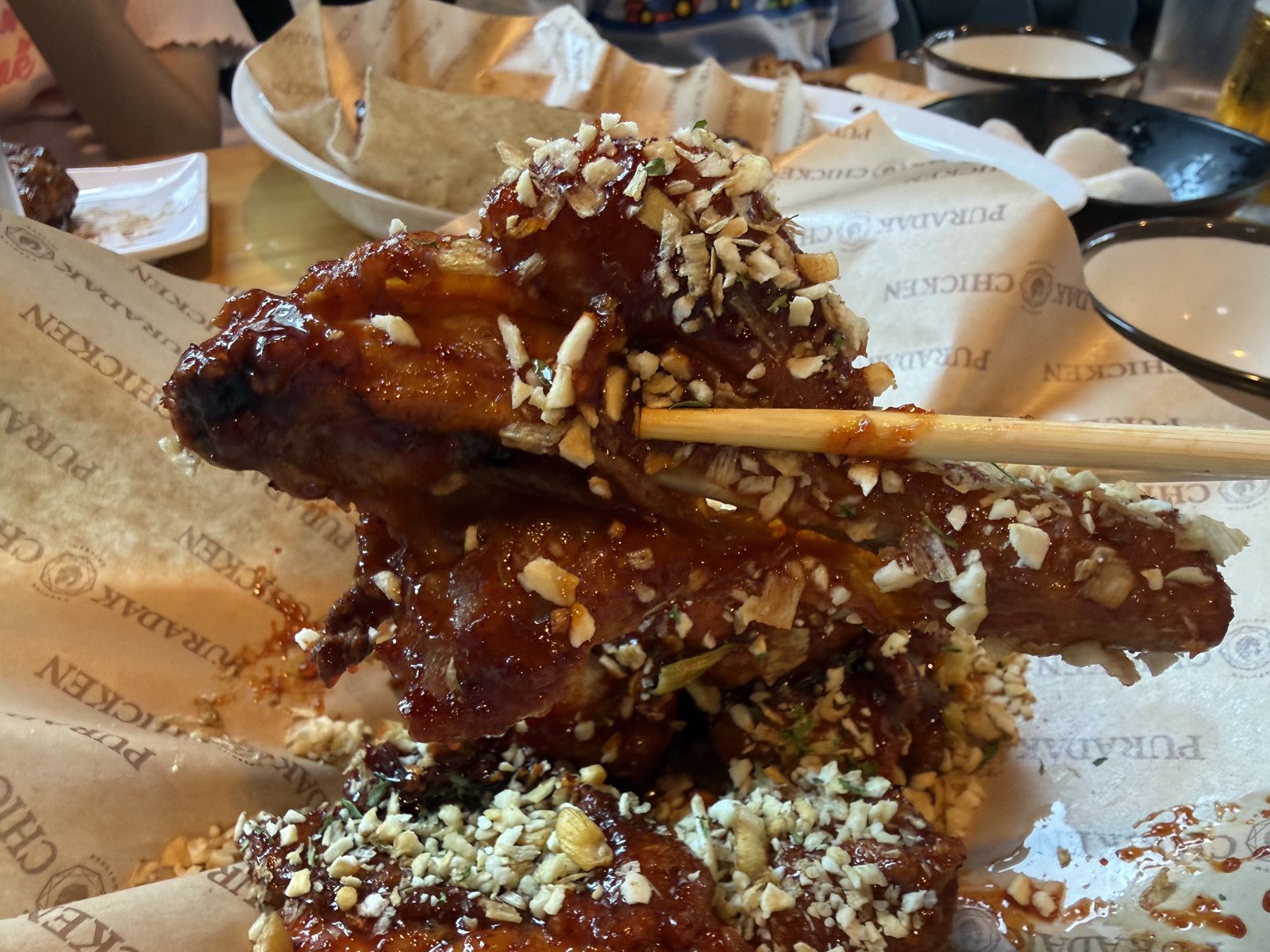Saucy Puradak chicken drumstick coated in glaze