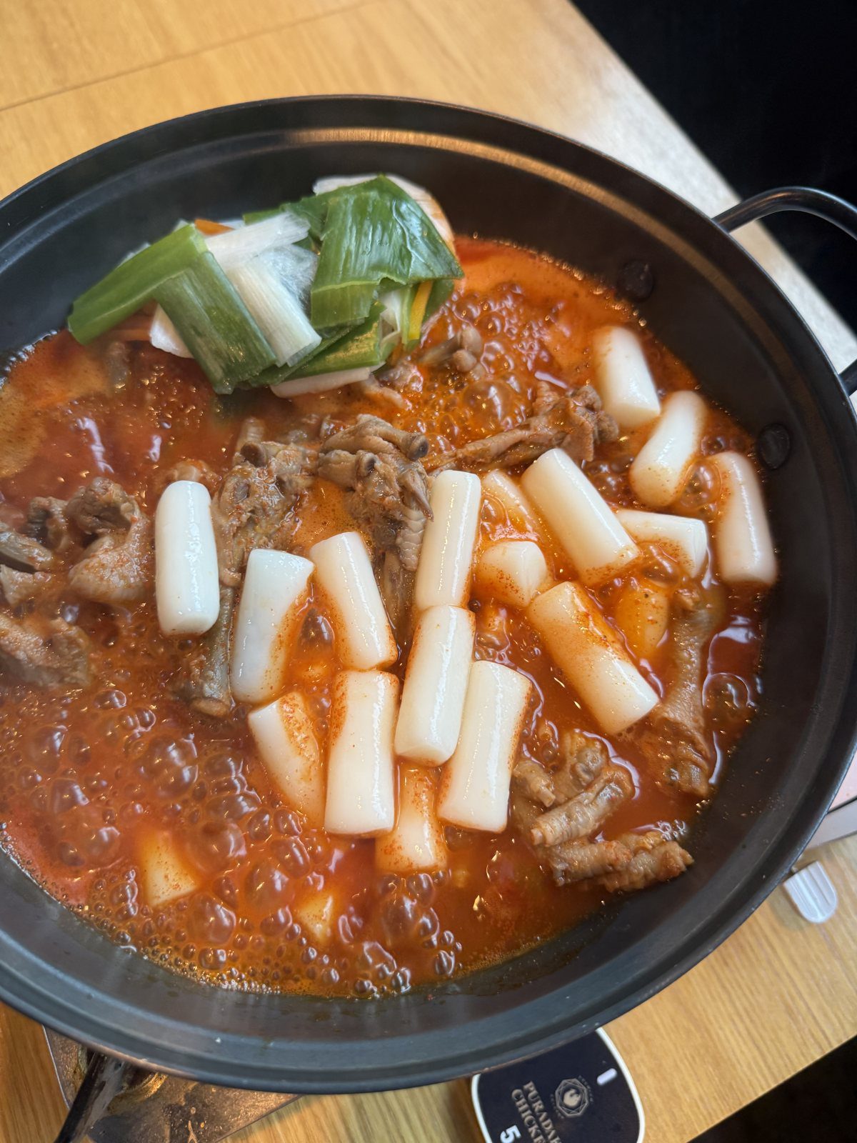 Spicy rice cake side dish served alongside Puradak chicken