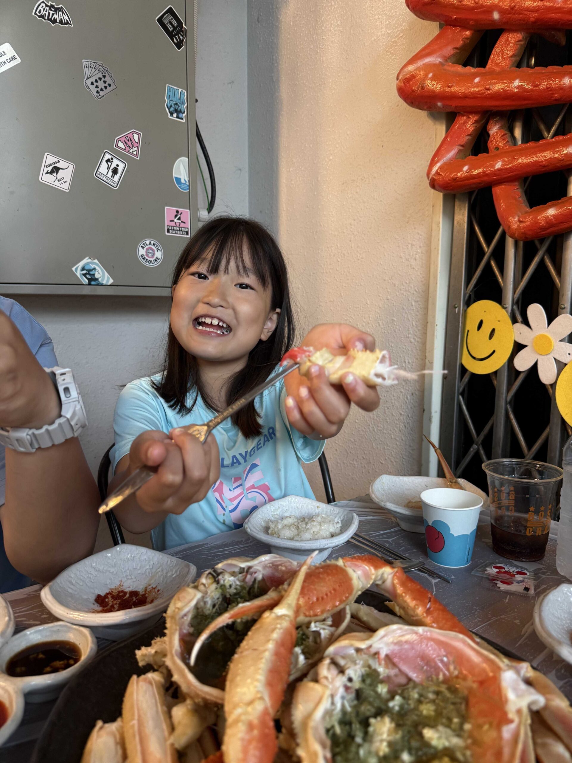 Child eating sweet Samcheok snow crab meat at Boss Daege