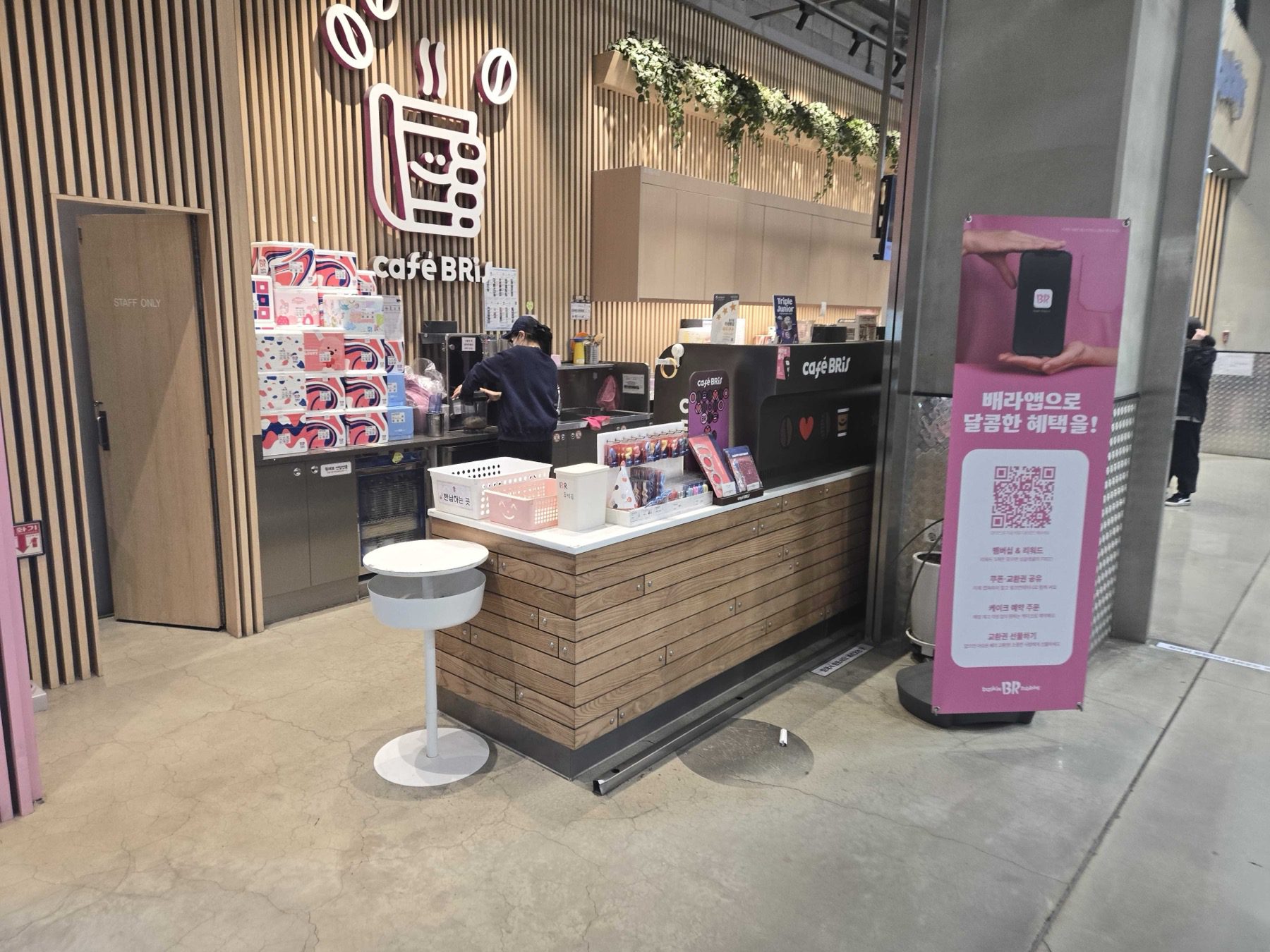 Cafe BRis coffee counter with staff and BR app banner at Baskin-Robbins Wirye Traders