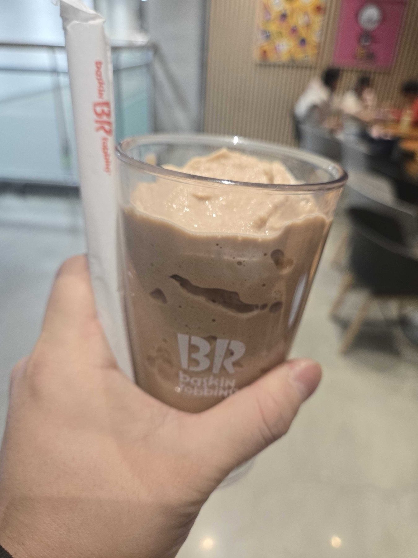 Cappuccino Original in a BR glass held up at Cafe BRis