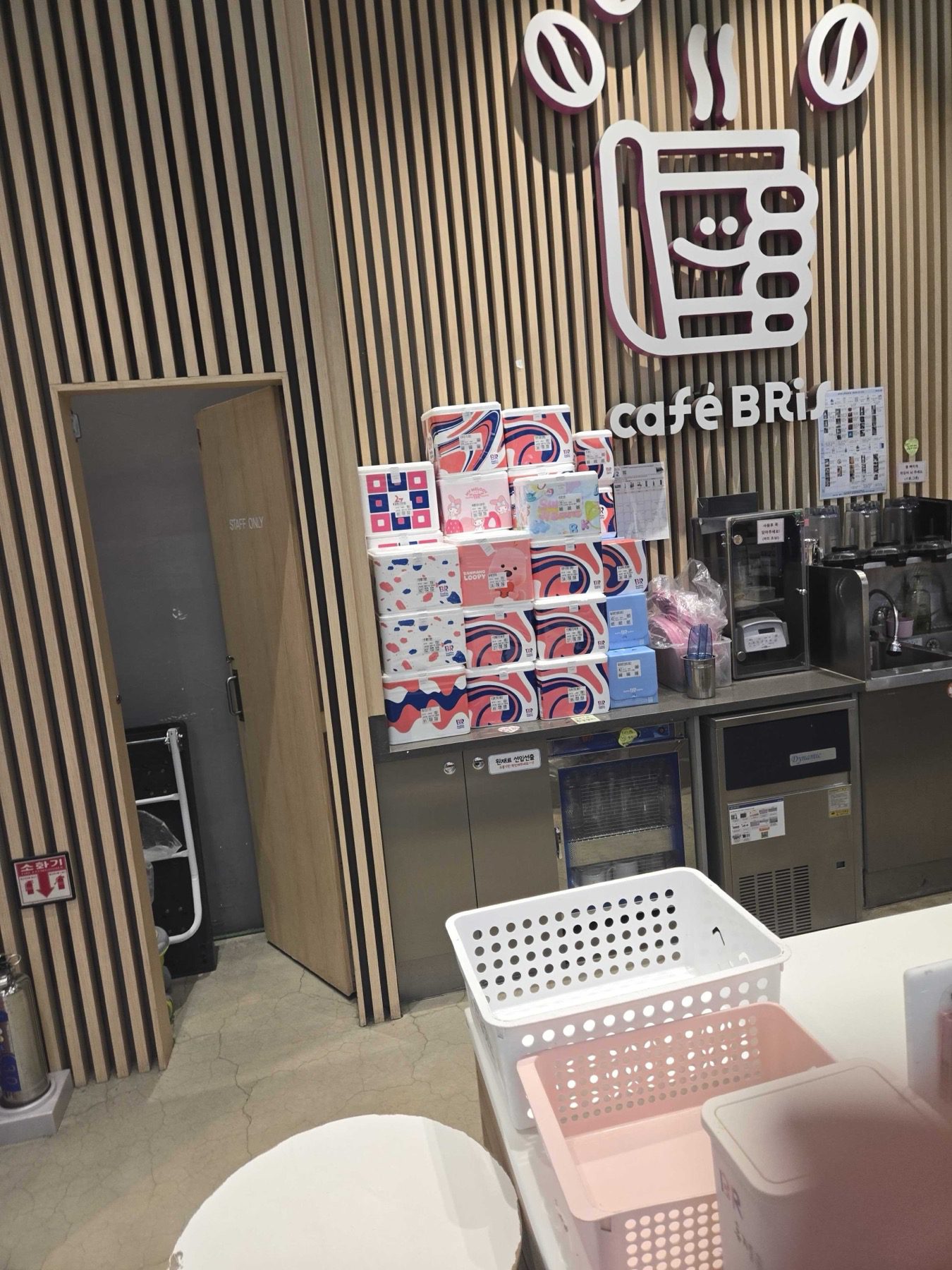 Collaboration pint boxes stacked at the Cafe BRis counter including My Melody and Zanmang Loopy designs