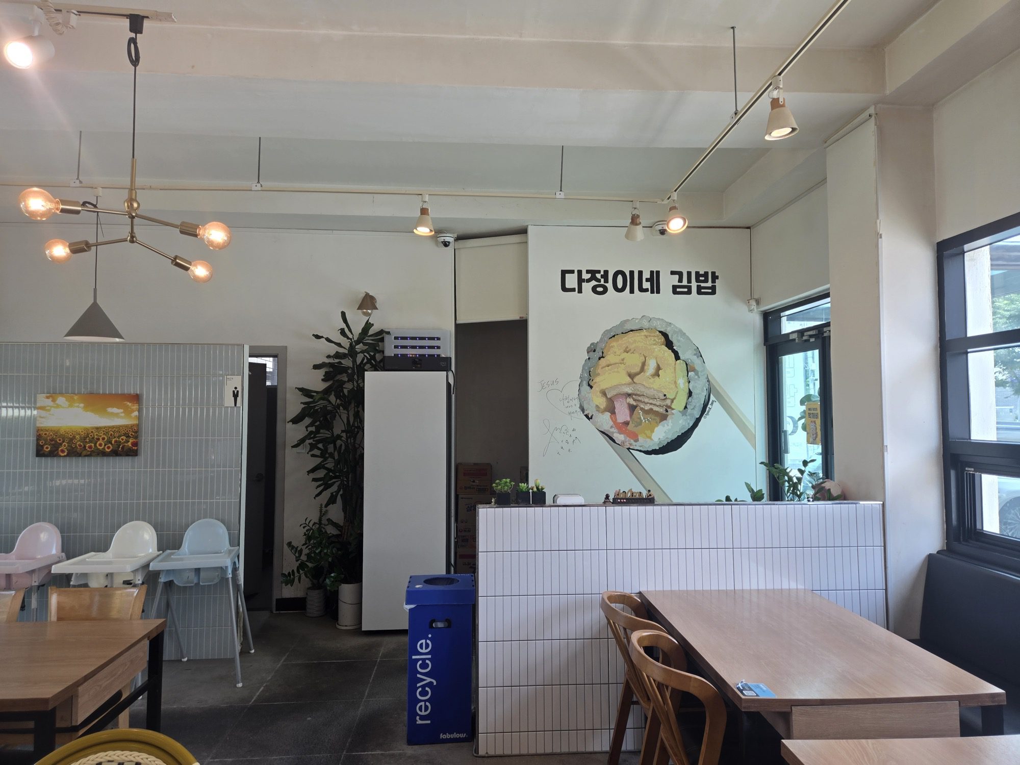 Bright interior with kids high chairs and gimbap wall art at Dajeongine Gimbap