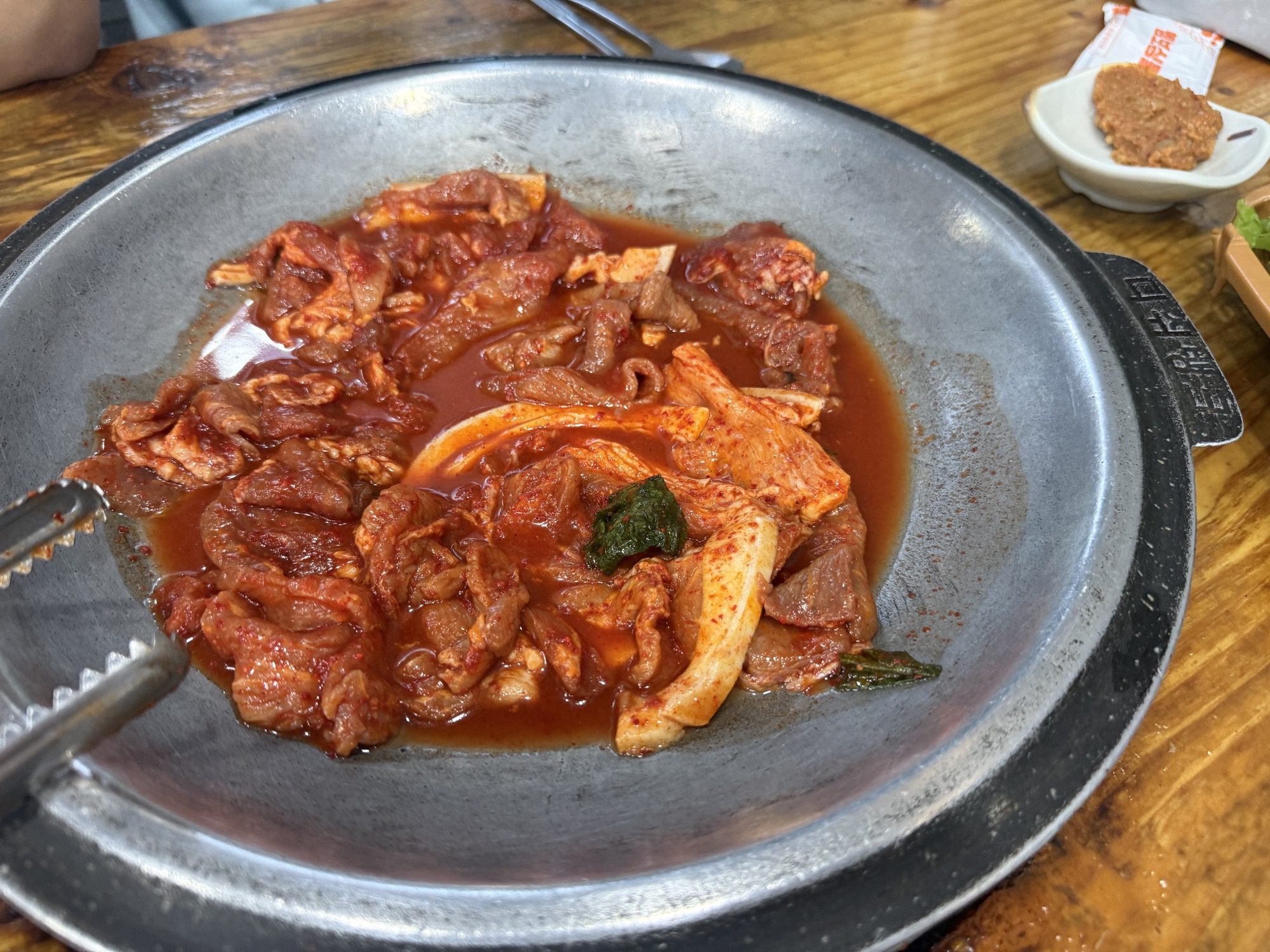 Close-up of spicy duruchigi pork in the pan at Gaseureum Sikdang