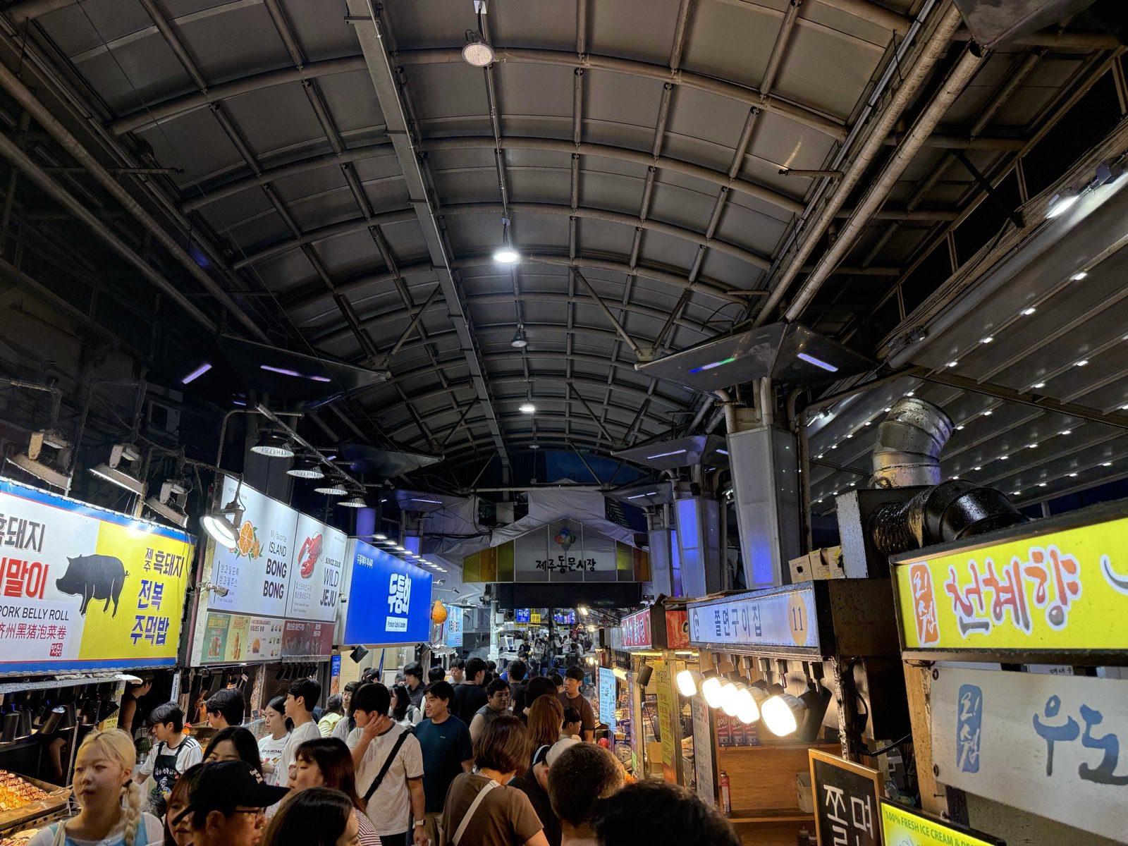 Busy night crowd in the Jeju Dongmun Market aisle