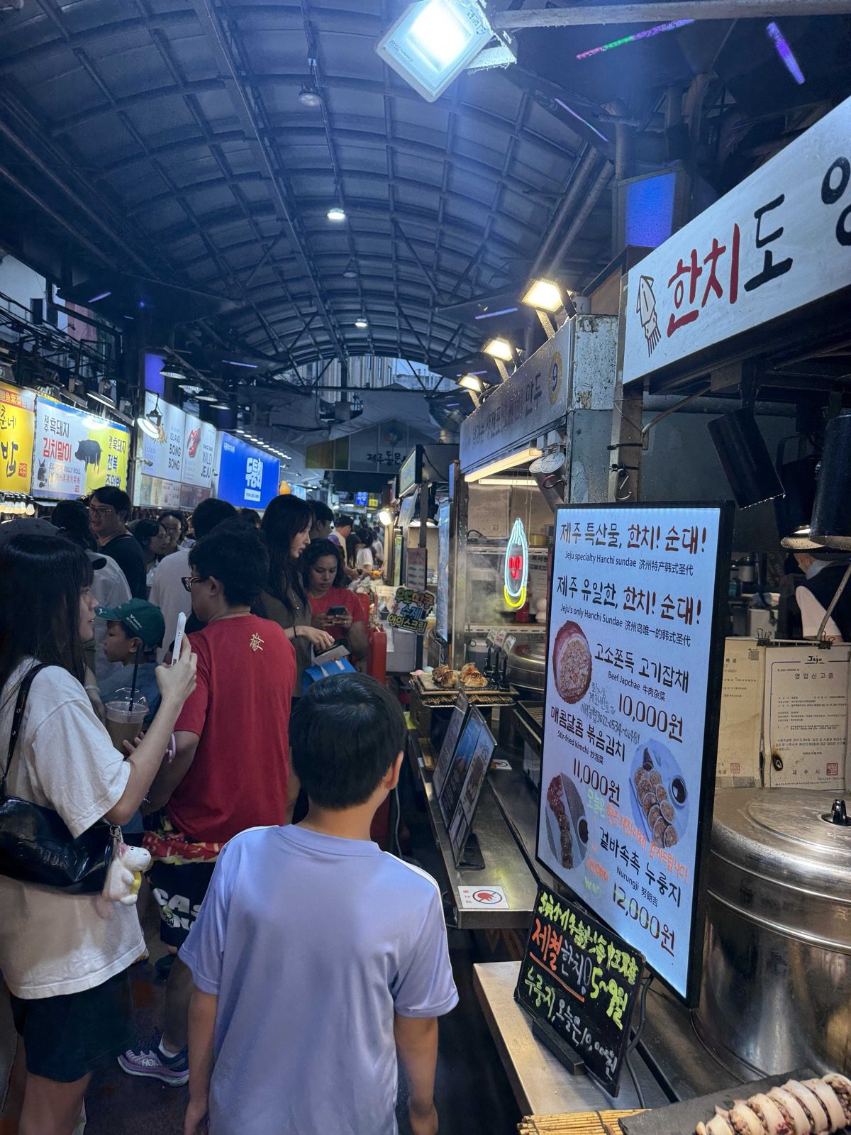 Walking into the Jeju Dongmun Market night market aisle