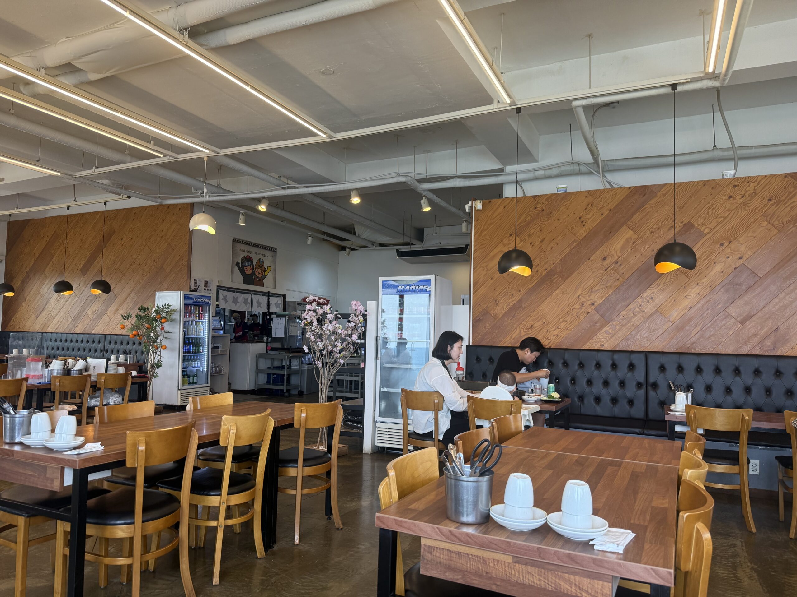 Jeju Gwanghae Aewol dining room with wood tables near the window