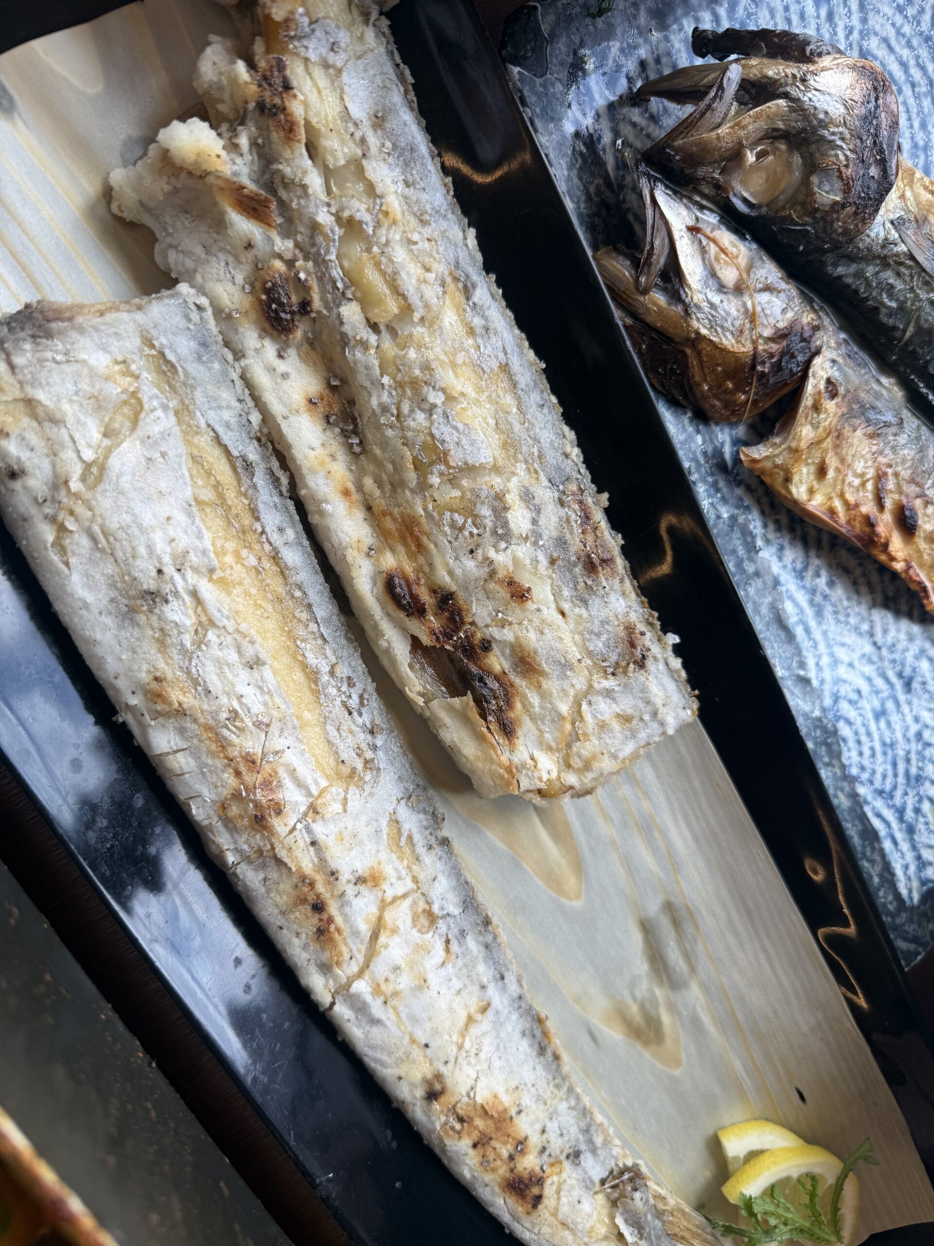 Grilled hairtail galchi gui on a wooden board at Jeju Gwanghae Aewol