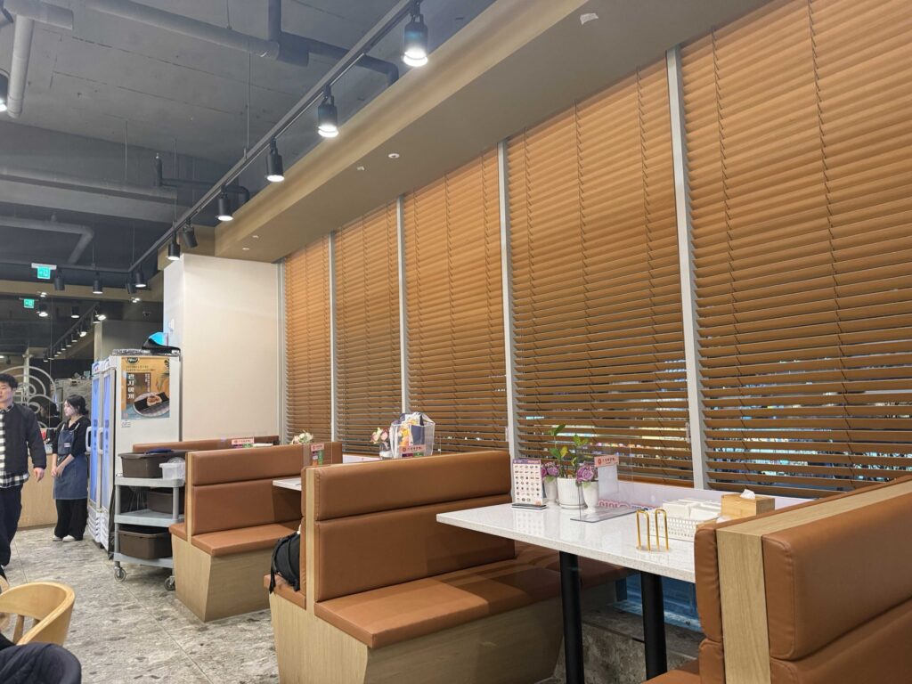 Tan leather booths and wooden blinds at Sushi Ian Wirye