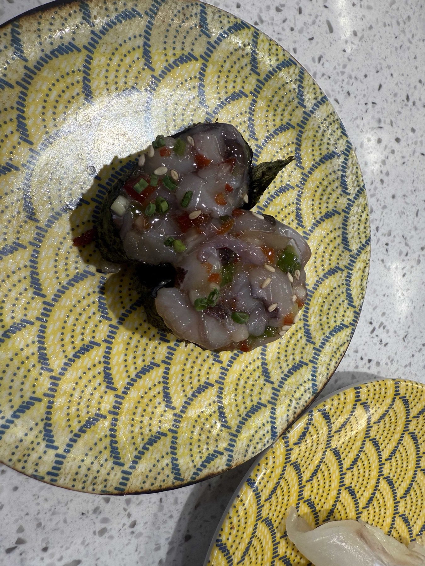 Chopped octopus salsa gunkan with peppers and sesame seeds at Sushi Ian Wirye
