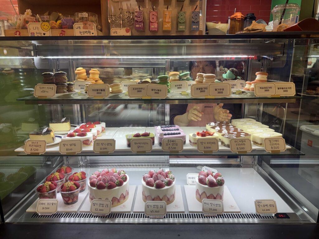 Whole strawberry cakes on the bottom shelf