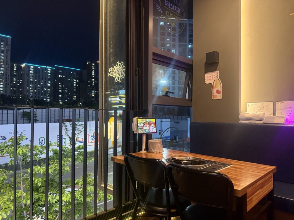 Our window table, with the tablet on the left and the apartment towers outside